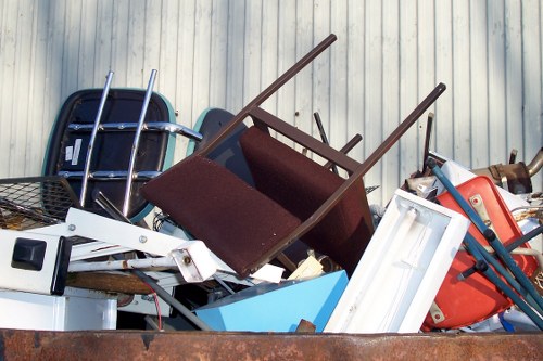 Two operatives with a van parked outside a terrace property preparing for clearance
